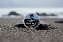 Beard balm container on a rock with a beach background