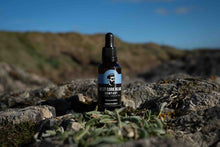 Beard oil sitting on a rock